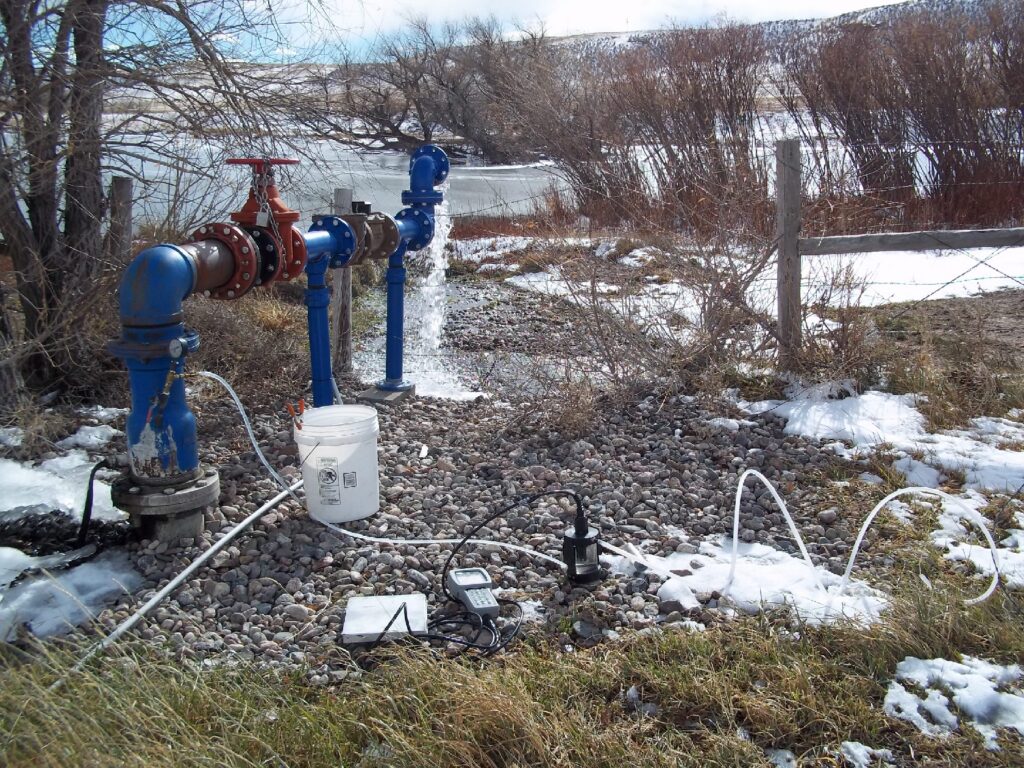 Photograph 11. An artesian irrigation well (Belvoir-Borie No. 1) feeds a pond in the east-central part of Area B. Natural flow from the well is about 30 gallons per minute.