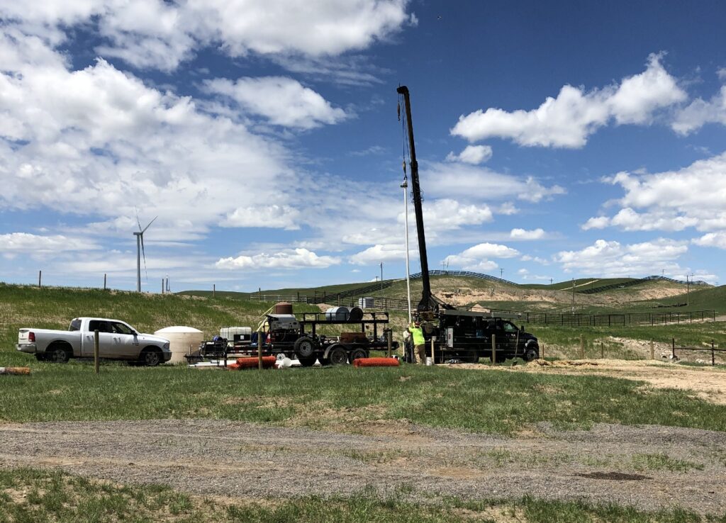 Photograph 13. The PTI Extraction Well EW01 is located 170 feet upgradient west of the Treatment shed and 870 feet upgradient of the Injection well. View is to the northwest, with the Treatment shed located just off the right side of the picture.